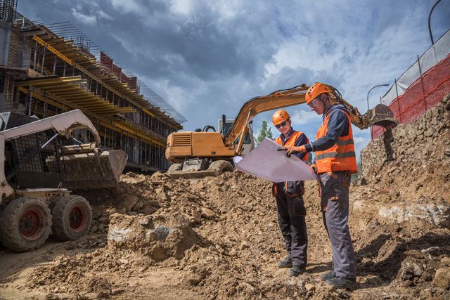 Two construction business owners at their worksite after fueling their vehicles using their Shell Fleet Card.